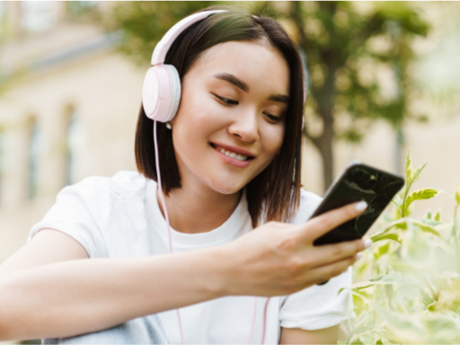 Student wearing headphones on phone