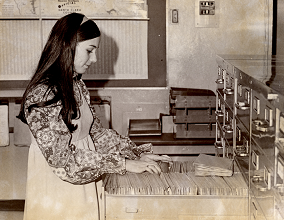 Patron using card catalog in 1960s